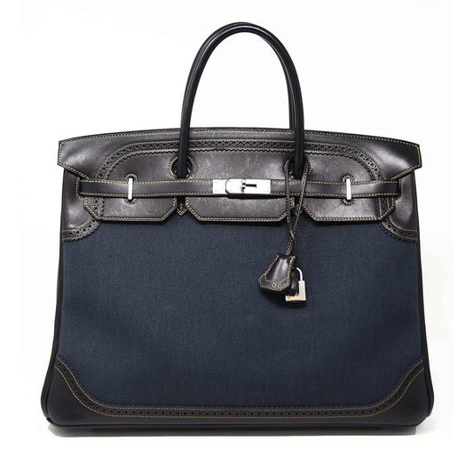 Deep Navy Woven Two-Tone Perforated Eyelet Trim Generous Sized Structured Hand Tote With Warm Contrast Edge Stitching, Brushed Silvery Twist Lock Hardware And Coordinating Trimmed Suspended Tag Compact Etched Metal Padlock Charm